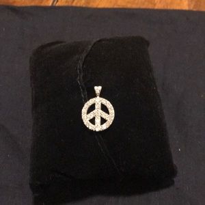 Silver and diamond peace sign necklace charm.